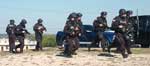 A group of people on motorcycles and cars.