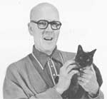 A man holding a black cat in his hands.