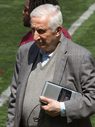 A man in a suit and tie holding a book.