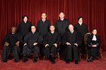 A group of people in black robes sitting on chairs.