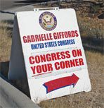 A sign that is on the side of a road.