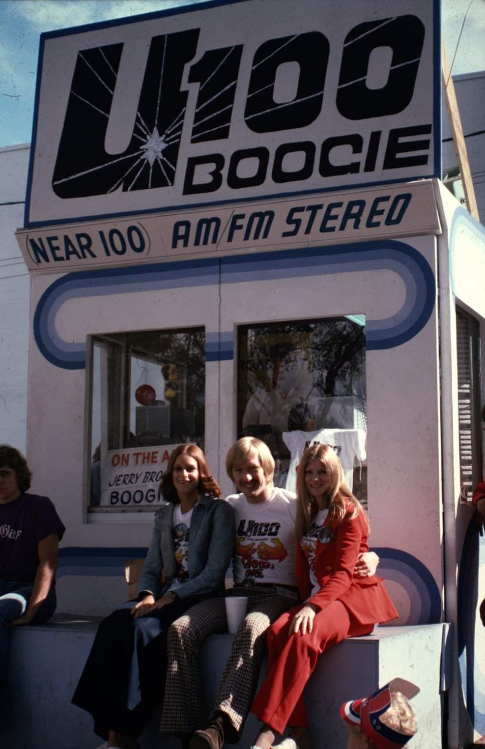Three young women posing in front of a radio station.